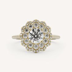 a white and yellow gold engagement ring with an oval center surrounded by small round diamonds