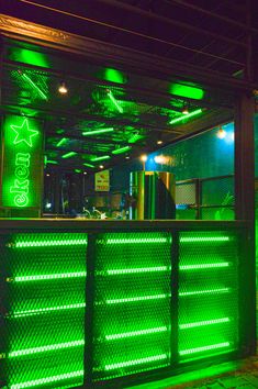 an outdoor bar lit up with green lights