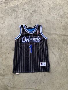 Vintage Orlando Magic Reversible Jersey Penny Hardaway Size M in great vintage condition. Size: M Material: Polyester measurement: - Chest(armpit to armpit: 52cm(20.4") - Length from the backside(Center bottom of the collar to center bottom of the garment): 67cm(26.3") - Shoulder to shoulder seam: 39cm(15.3") NOTE: Because of the age, clothing can shrink or the sizing from that time wasn't the same as the size from modern clothing. Make sure you have checked our measurements first before purchas Collegiate Sleeveless Top For Streetwear, Sleeveless Cotton Jersey For Sports Season, Sleeveless Cotton Jersey For Streetwear, Cotton Sleeveless Jersey For Streetwear, Sleeveless Cotton Jersey For Sports, Casual Sleeveless Cotton Jersey, Collegiate Sleeveless Jersey Top, Casual Sleeveless College Jersey, Throwback Jersey Tops For Streetwear