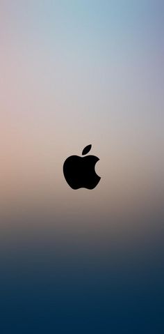 an apple logo is shown in front of a blue and pink sky with the sun behind it