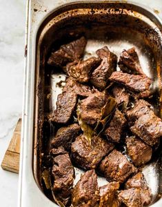 a pan filled with cooked meat on top of a counter