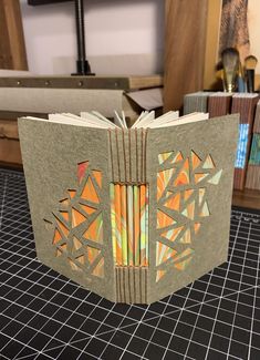 an open book sitting on top of a table next to bookshelves and other items