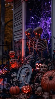 halloween scene with skeletons and pumpkins in front of house decorated for the day of the dead