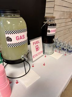 a table with gas station signs and water bottles