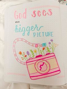 an open notebook with the words god sees, he's bigger picture on it