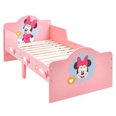 a pink bed with minnie mouse head on it