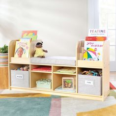 a child's book shelf with books and toys