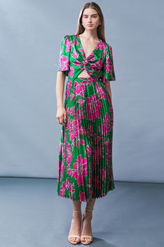 A printed woven midi dress featuring V neckline, front twist and cut out detail, short flutter sleeve, pleated skirt and elasticized back waist Look stunning in our Certified Charm Woven MIDI Dress, designed to flatter your silhouette with its structured V-neckline, intricate front twist and cut-out detail, and voluminous pleated skirt. Crafted from lightweight printed fabric, with delicate flutter sleeves and an elasticized back waist, this dress is sure to elevate your wardrobe with its sophis Spring Midi Length Dress With Twist Front, Spring Midi Length Twist Front Dress, Spring Twist Front Midi-length Dress, Green Midi Dress With Pleated Waist And Short Sleeve, Pleated V-neck Midi Dress For Day Out, Green Surplice Neckline Midi Dress For Brunch, V-neck Pleated Midi Dress For Day Out, Green Casual Dress With Pleated Skirt, Spring Dress With Twist Front And Surplice Neckline