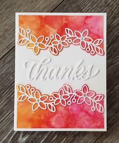 a handmade thank card with watercolor flowers and the word thanks written on it