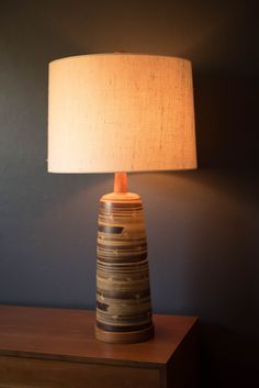 a table lamp sitting on top of a wooden dresser