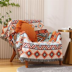 an orange and white patterned chair with a pillow on it