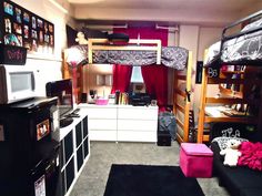 a dorm room with bunk beds, desks and other items in it's storage area