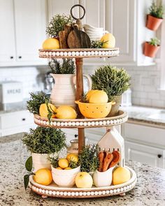 three tiered trays filled with lemons and herbs