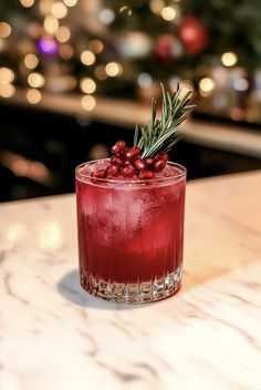 a red drink sitting on top of a counter next to a christmas tree