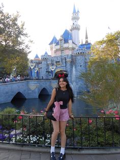 a woman standing in front of a castle