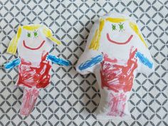 two paper dolls made to look like they are holding hands