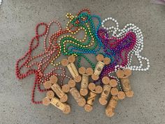 several wine corks are laid out on the ground next to each other with different colored beads