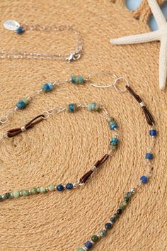 Indulge in the beauty of the sea with our Pacifica Collection! Each piece is meticulously handcrafted with stunning shades of blue, capturing the essence of ocean waves and clear skies. Sterling Silver (Lead & Nickel Free) Lapis, Chrysocolla, Jasper 36-38" adjustable with sterling silver lobster claw clasp We hand select our natural materials, thus there may be slight variations in color and/or size that will not detract from the overall aesthetic. Our unique handcrafted designer jewelry for women is made in America, each design created individually in our personal design studio in Floyd, VA USA Handmade Adjustable Ocean Color Necklace, Artisan Blue Jewelry For Beach, Artisan Blue Jewelry For The Beach, Turquoise Hand Wrapped Beach Necklace, Turquoise Hand Wrapped Necklace For Beach, Turquoise Hand Wrapped Necklaces For Beach, Beach Jewelry Blue Hand-wrapped, Blue Long Necklace For Beach, Blue Hand Wrapped Jewelry For The Beach