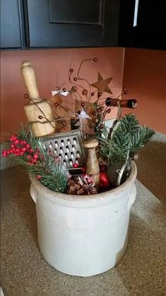 a white bucket filled with lots of christmas items on top of a counter next to a wall