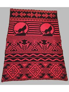 a red and black knitted blanket with a wolf in the middle, on a gray background