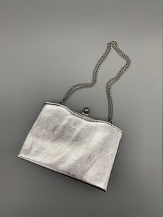 "Glitzy and glamorous little purse. Silver Lame Evening Bag by Harry Levine (labeled on the interior as HL U.S.A.). Silver chain strap, silver frame & clasp and silver satin interior. A cute little detail on this -- the outer edges of the purse are open and lined with a light, rose-pink satin (photo 8 shows it best). A couple dents in the exterior, some staining/discoloration along the top edge of the interior (visible in photos). The silver frame also shows some wear/scuffing. I did not make any cleaning attempts on it!  Measurements: Height: 5\" Width (overall): 7\" Width of opening: 5.375\" Strap drop: 7.5\" Please message me with any questions!" Glamorous Silver Shoulder Bag With Chain Strap, Silver Clutch Evening Bag With Chain Strap, Chic Silver Clutch With Chain Strap, Silver Rectangular Evening Bag With Chain Strap, Silver Metal Shoulder Bag For Party, Silver Shoulder Bag With Silver-tone Hardware As Gift, Silver Evening Bag With Chain Strap For Events, Silver Metal Rectangular Shoulder Bag, Elegant Metallic Silver Shoulder Bag For Party