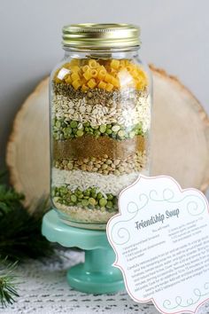 a jar filled with different types of food on top of a table next to a sign