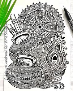 a coloring book with an intricate design on the cover and two pens next to it