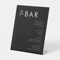 a black and white menu card with the word'the bar'written on it