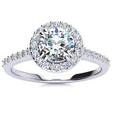 a white gold engagement ring with diamonds on the band and an oval halo setting in the center