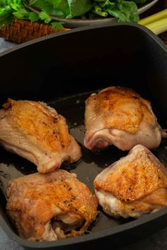 four pieces of chicken in a skillet