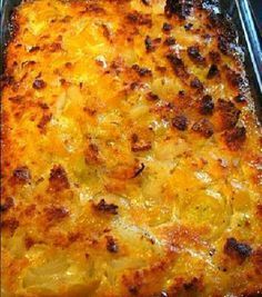 a casserole dish with cheese and onions in a glass pan on the stove