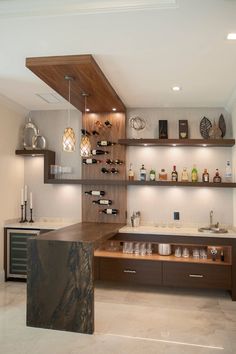 a kitchen filled with lots of counter top space next to a wall mounted wine rack