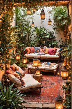 an outdoor living room with lots of plants and lights on the ceiling, surrounded by greenery