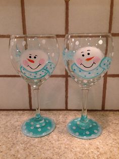 two wine glasses with snowmen painted on them