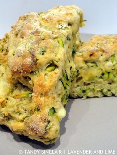 broccoli and cheese scones stacked on top of each other with one piece cut out