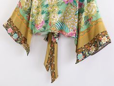 Our beautiful Metella Boho Kimono has a bold and vibrant floral with peacocks print design. Made from a lightweight cotton blend that will look great both as a summer layer or on the beach.Specs: Material: Cotton/ Rayon Fits true to size, take your normal size Spring Yellow Tops With Printed Motifs, Spring Beachwear Top With Vibrant Print, Multicolor Print Beachwear Top For Summer, Summer Beachwear Tops In Multicolor Print, Summer Beachwear Tops With Multicolor Print, Vibrant Print Beachwear Tops For Summer, Floral Print Beachwear Tops For Spring, Spring Beachwear Tops With Floral Print, Summer Beachwear Tops With Vibrant Print