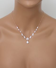 This dainty yet radiant rose gold CZ bridal necklace and earring set is the perfect accessory for any bride looking to add a glamorous touch! PLEASE ALLOW APPROX 5-7 BUSINESS DAYS FOR COMPLETION BEFORE SHIPPING - Handcrafted with Premium Cubic zirconia stones - Necklace measures 16" (Length) 2" (Extender) 1.25" (Drop)- Earrings measure 1" - Available in rose gold, yellow gold and rhodium (silver) finishes - Nickel free and hypoallergenicThis is an original design by © Treasures by Agnes Gold Necklace Set Bridal, Rose Gold Necklace Set, Rose Gold Earrings Wedding, Jewelry Rose Gold, Gold Earrings Wedding, Bracelet Rose Gold, Bridal Jewelry Set, Necklace Men, Gold Necklace Set