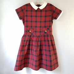 "- This adorable vintage dress is perfect for cooler weather! The fabric is a super soft velvet in a soft pink. It has short sleeves and buttons at back. There is a wide, off-white lace ruffle around the neck. The cut is a simple A-line shape. Size: approx 12 months Length: 14..5\"	is_active	6769639	Apparel & Accessories > Clothing > Baby & Toddler Clothing > Baby & Toddler Dresses	https://www.etsy.com/listing/616062825/vintage-60s-girls-pink-velvet-dress-with	clothing > Preppy Gingham Dress For School, Fitted Plaid School Dress, Fitted Plaid Dress For School, Casual Plaid Dress For School, Classic Short Sleeve Plaid Dress, Preppy Plaid Cotton Dress, Red Short Sleeve School Dress, Fall Plaid Dress With Short Sleeves, Preppy Fitted Plaid Cotton Dress