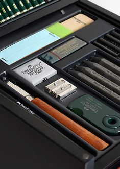 an open drawer containing several different types of pens and pencils, including one for each individual