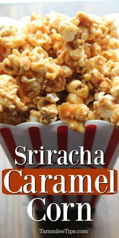 a bowl filled with caramel popcorn sitting on top of a wooden table next to a red and white striped napkin