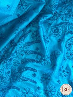 This exquisite blue silk piece showcases intricate Chikankari embroidery, a handcrafted technique that dates back to the Mughal era. Designed to elevate any outfit, this one-of-a-kind piece exudes timeless elegance and luxury. Experience the art of Chikankari and indulge in the finest craftsmanship with this stunning silk creation. Chikankari on Silk - Blue Saree comes with a blouse piece. Fall and pico done. Fully stitched blouse shown in pictures is optional and can be purchased seperately from our blouses and croptops section. For saree video please connect with us on whatsapp @469-937-0606 Ready to be shipped in USA from San Diego, California. All pictures are original pictures. Colors may slightly vary due to pic resolution. Elegant Blue Blouse Piece With Intricate Embroidery, Blue Silk Dupatta For Festivals, Blue Tussar Silk Dupatta With Motifs, Unstitched Blue Tussar Silk Blouse Piece, Blue Semi-stitched Tussar Silk Blouse Piece, Semi-stitched Blue Tussar Silk Blouse Piece, Festive Blue Tussar Silk Traditional Wear, Blue Silk Blouse Piece With Motifs, Blue Silk Traditional Wear For Festivals