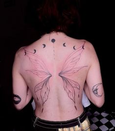 a woman with tattoos on her back