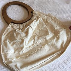 "Vintage 1970s Cotton Boho Bag. Muslin Cotton Lace and Purse With Oval Wooden Handles. Inside Pocket. Hippie Cloth Handbag. This cotton purse is in good shape. It looks like it was never used. It is unstained and beautiful. Size: 13 1/2\" X 9 1/2\", Handle: 7\" X 8\" For other vintage and homemade items see: www.VeryVictorianStudio.etsy.com For sewing related items see my other shop: www.SewingRoomStore.etsy.com Thank you for looking!" Retro Beige Shoulder Bag For Summer, Beige Retro Shoulder Bag For Summer, Vintage Summer Shoulder Bag, Vintage Beige Shoulder Bag For Summer, Vintage Beach Bag For Spring, Vintage Beige Shoulder Bag For Spring, Vintage Beige Cotton Bags, Vintage Beige Hobo Tote Bag, Vintage Cream Shoulder Bag For Vacation