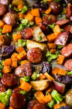 a pan filled with sausage, broccoli and sweet potatoes