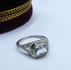 Antique Art Deco marked 10k white gold filigree & clear topaz/aquamarine? ring size 6, In good antique condition. The stone some scratch grom age, The pictures is part description.  Sold as is, The face of the ring 9 mm x 10 mm, Stone 8 mm x 6 mm. Weighs 2.4 gram. Thanks. Ship US only Vintage White Emerald Cut Ring, Vintage Silver Topaz Ring With Diamond Cut, Vintage Silver Emerald-cut Topaz Ring, Vintage Silver Topaz Ring Emerald Cut, Antique White Filigree Ring With Diamond Cut, Heirloom Silver Topaz Ring With Diamond Cut, White Gold Art Deco Topaz Ring With Center Stone, Antique White Filigree Ring For Formal Occasions, Heirloom White Gold Topaz Ring With Prong Setting