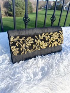 This is our gorgeous clutch that comes in a black color with a yellow and red design in the front. The clutch closes with a magnetic button and there is also a zipper in the inside for your more valuable items. It's the perfect size and will elevate any outfit! DIMENSIONS:  10 inches x 6 inches Black Envelope Evening Bag For Formal Occasions, Black Pouch Clutch As Gift, Black Clutch Evening Bag As Gift, Black Clutch Evening Bag For Gift, Black Evening Clutch Bag, Black Pouch Wallet For Evening, Black Clutch As A Gift, Black Clutch Wallets As Gift, Black Envelope Clutch For Formal Occasions