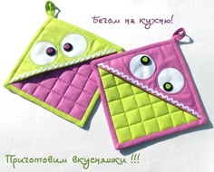 two pink and green oven mitts with eyes on them