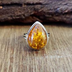 Handmade Amber Ring Gift for Her, 925 Solid Sterling Silver Ring, Pear Shape Boho Ring, Gemstone Ring, Statement Ring for Womens All my design are original with Solid 925  Sterling Silver stamp. # PRODUCT DETAILS * Product: Silver Stone Ring * Metal: 925 Sterling Silver Jewelry * Gemstone: Amber * Size: all size ring * Stone shape: Pear * Stone Color: Orange * Setting: Handmade # GENERAL INFORMATION This Amber ring is for women and men You will receive a Ring like the one in the photos This Ring have 925 Stamp Suitable for use in everyday situation s, or can also be use as a gift for her/him. Unique and beautiful design will make a special attraction for the wearer. I make my jewelry with love and passion. The perfect gift for a special occasion and other parties See more items on my Shop: Handmade Silver Pear-shaped Rings, Handmade Pear-shaped Silver Rings, Sterling Silver Teardrop Rings Stamped 925, Sterling Silver Pear Ring Gift, Pear Shaped Sterling Silver Ring For Gift, Pear-shaped Sterling Silver Ring For Gift, Classic Teardrop Rings For Gift, Teardrop Hallmarked Ring For Anniversary, Handmade Teardrop Ring For Anniversary