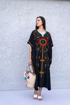 "This beautiful Kaftan with the Siwa inspired embroidery is a bohemian and flashy dress that will catch everyone's eyes. This Kaftan is ideal to wear for any casual occasion. Whether taking a trip down the shopping lane, or home-based kitty parties, or about anything else, wearing this dress will make you feel classy and comfortable. Fabric : 70% Egyptian Cotton; 30% Polyester. Size : Free sized dress. This Kaftan is a free sized dress meaning that it comes in one size only that fits any size fr Black Bohemian Tunic Thobe, Bohemian Black Thobe Tunic, Bohemian Black Thobe In Tunic Style, Black Bohemian Style Thobe, Traditional Black Kaftan For Vacation, Traditional Black Embroidered Thobe, Black Folk Style Beach Dress, Traditional Long Black Kaftan, Traditional Black Thobe With Floral Embroidery