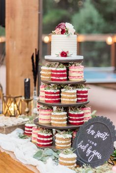 a cake and cupcakes are stacked on top of each other at a wedding reception